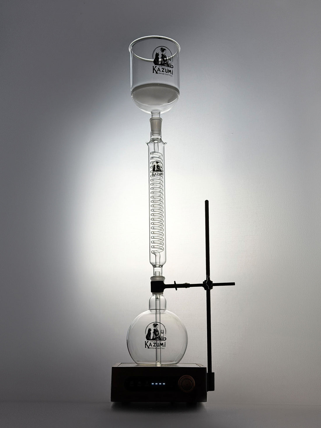 Kazumi siphon coffee maker brewing on a stove